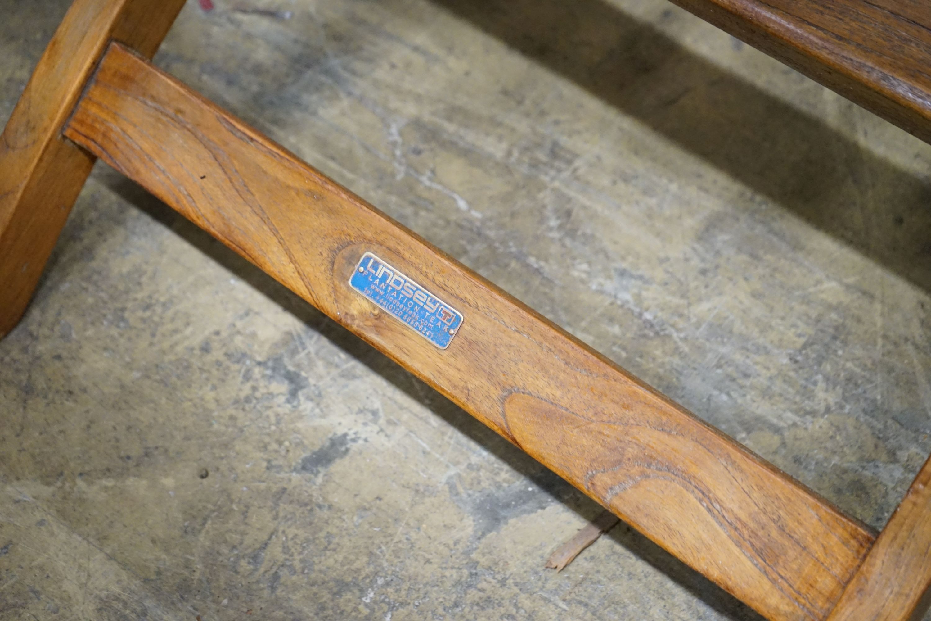 A brass mounted teak garden steamer chair, labelled Lindsey